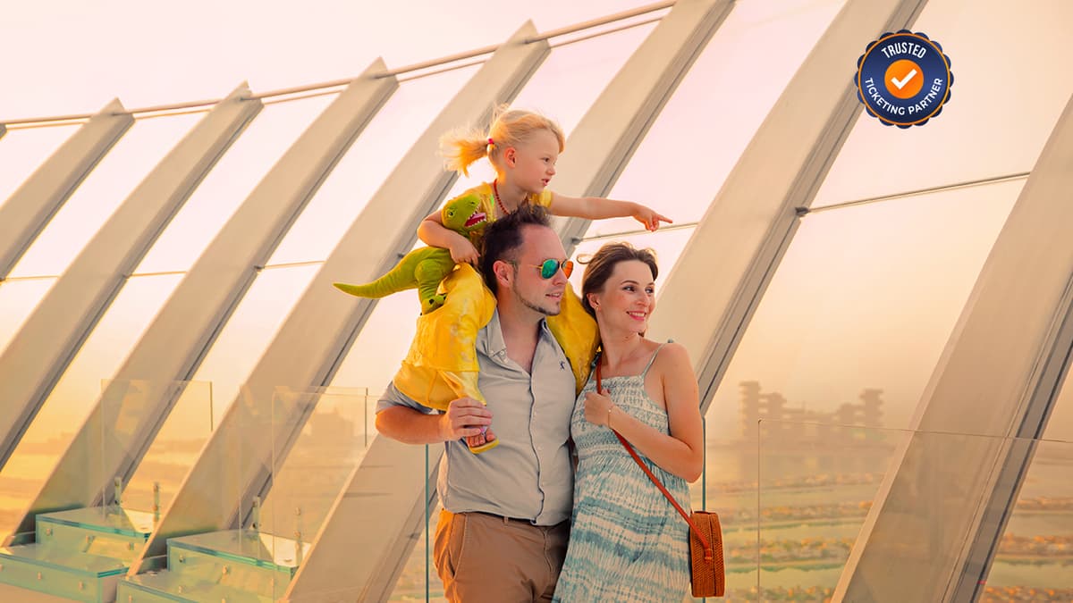 Family enjoying the panoramic view of Palm Jumeirah from an outdoor observation area