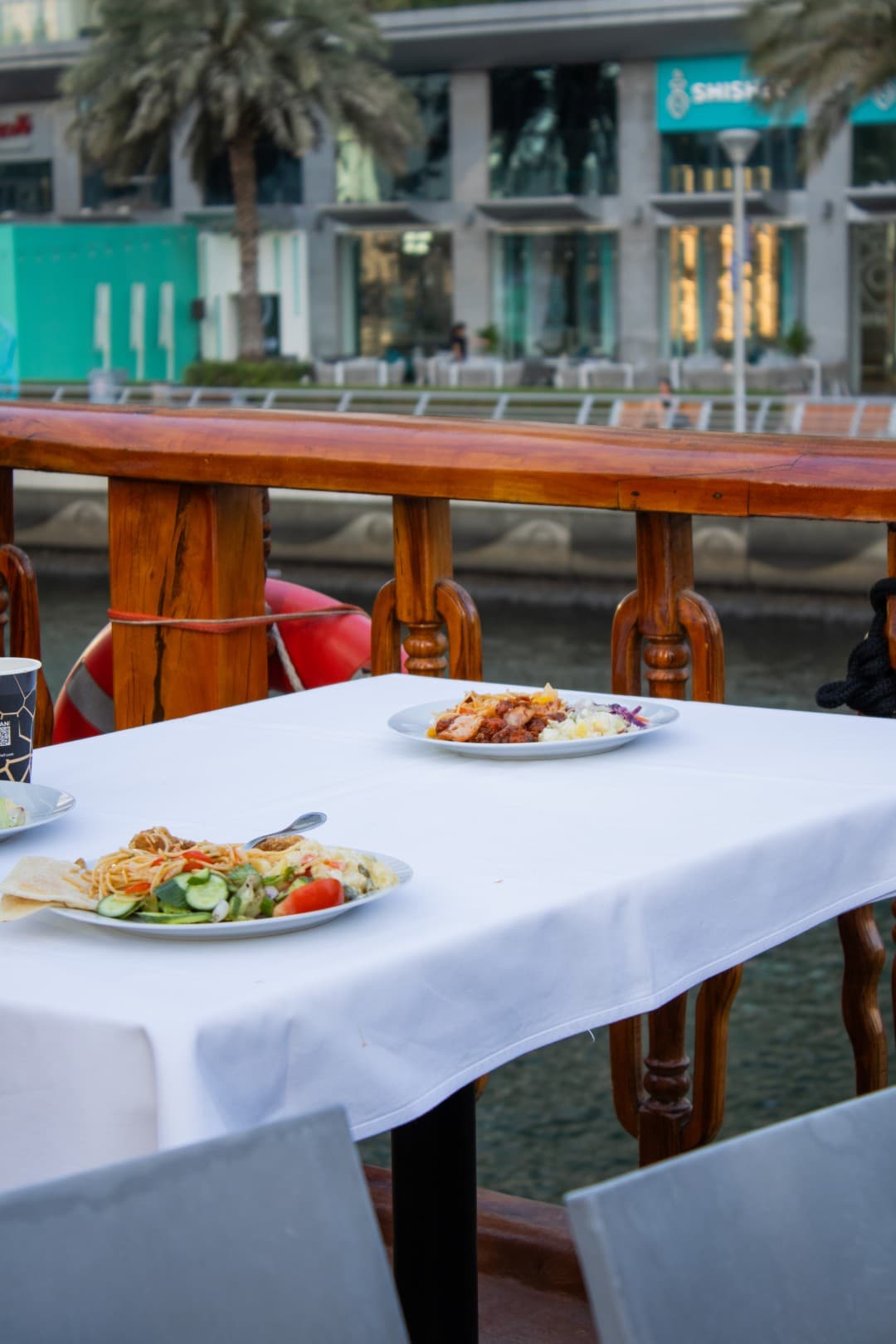 Elegant table seating setup on a Marina dhow cruise at sunset