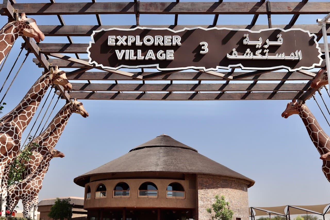 Visitors exploring the Explorer Village at Dubai Safari Park with wildlife habitats and safari experiences.