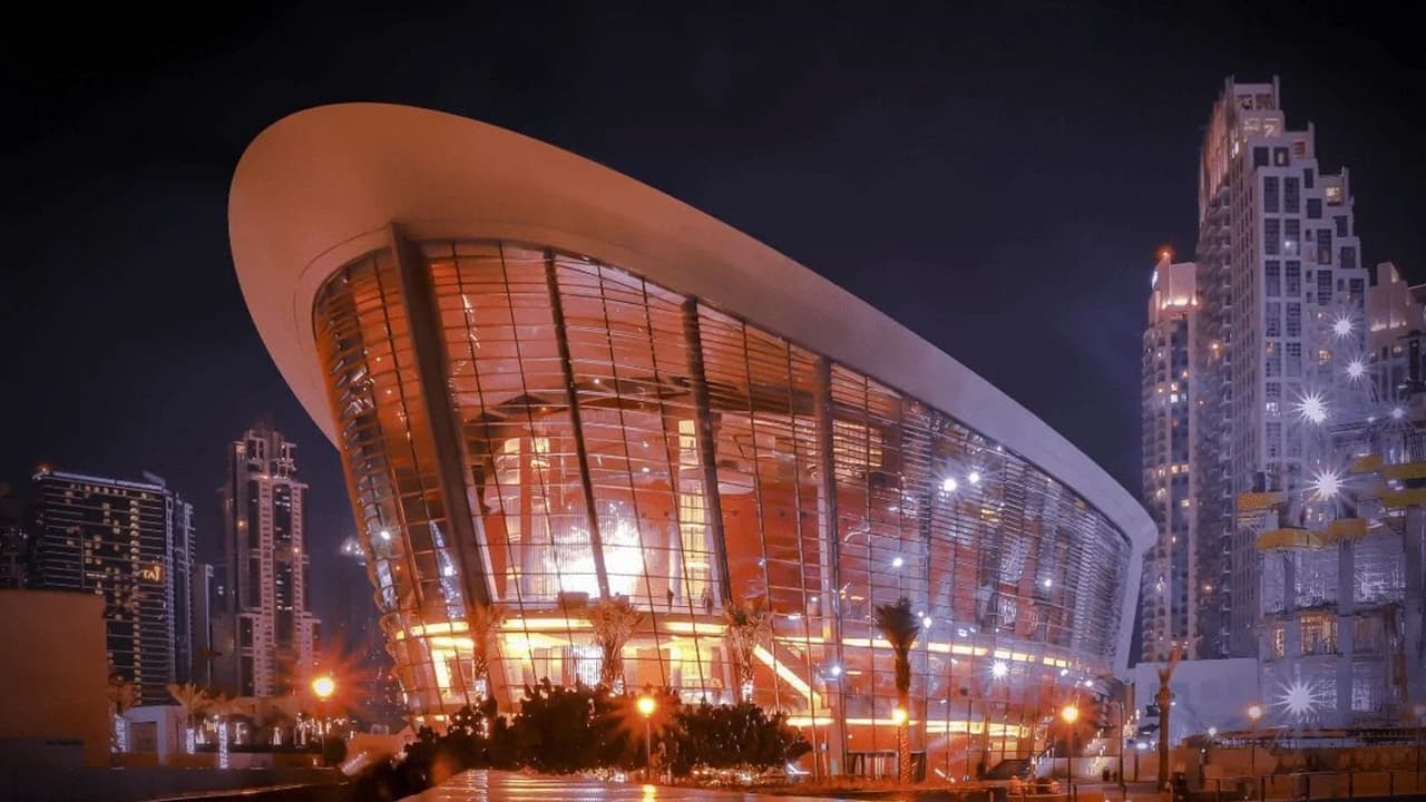 Entrance of the Dubai Opera Grand Tour with the modern glass façade of Dubai Opera and visitors