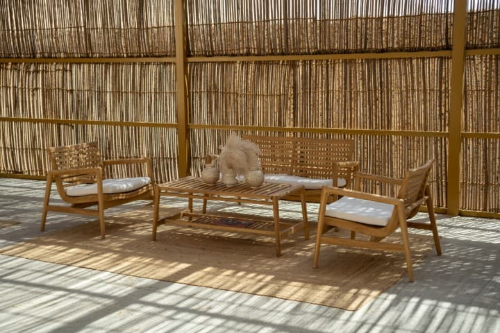 Wooden patio featuring a table and chairs, set up for a camp dinner briefing area.