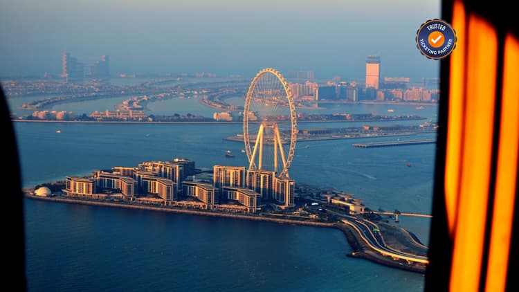 Aerial helicopter view of Ain Dubai observation wheel and Bluewaters Island during a Dubai helicopter tour