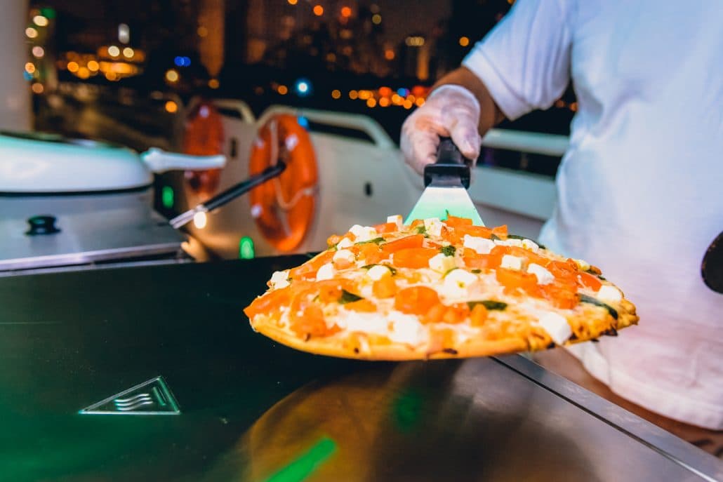 Fresh food being prepared at cooking station on mega yacht cruise