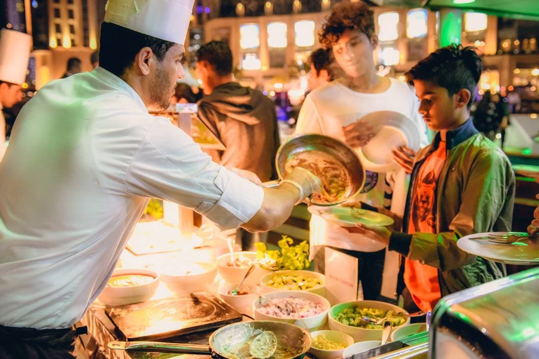 Kids enjoying a variety of dishes from buffet on Lotus Mega Yacht