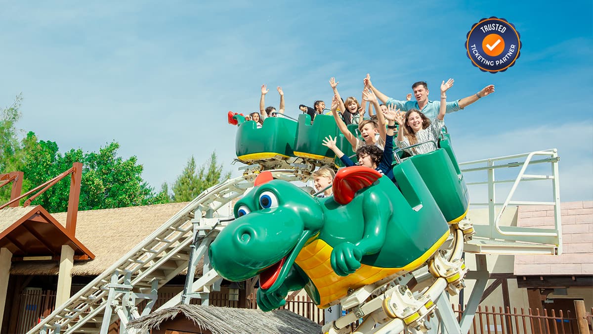 Colorful LEGO-themed rides and attractions at LEGOLAND Dubai with families enjoying the park.