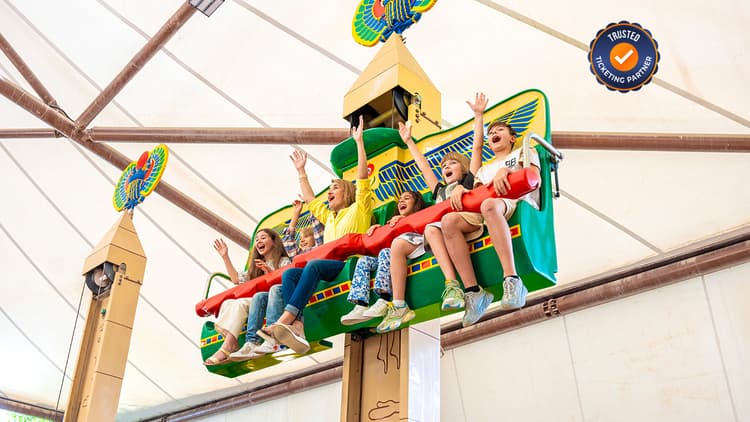 View of multiple LEGO-themed rides and attractions at LEGOLAND Dubai with visitors enjoying the theme park