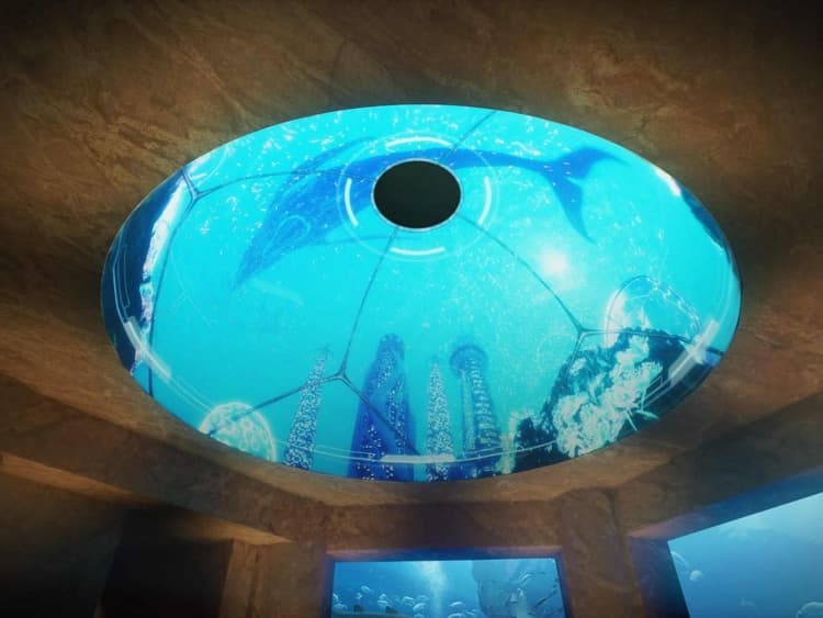 A large aquarium with a dome-shaped ceiling, showcasing marine life at Atlantis Aquaventure and Lost World Aquarium.