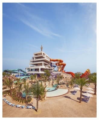 Aerial view of Atlantis Dubai water park featuring numerous colorful slides and pools.