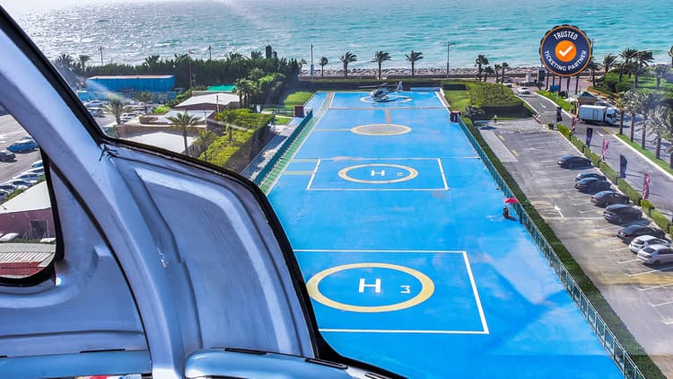 Helicopter flying over Dubai landmarks during the Iconic Helicopter Tour experience.